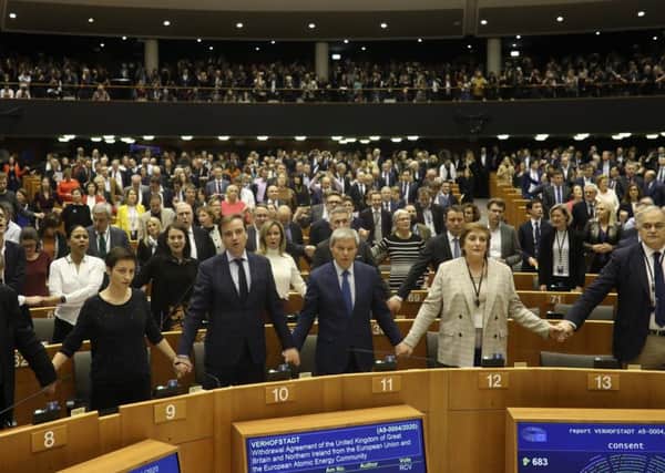 MEPs linked hands and sang Auld Lang Syne during an emotionally-charged vote on Wednesday evening. Picture: AFP/Getty Images