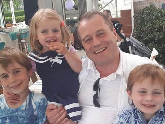 Conor McGinley, 9, Darragh McGinley, 7, and Carla McGinley, 3, with their father Andrew McGinley. Picture: Family Handout/PA Wire