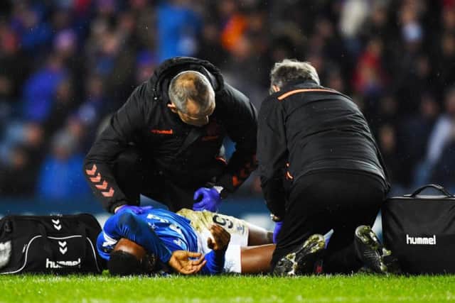 Jermain Defoe receives treatment on the Ibrox turf