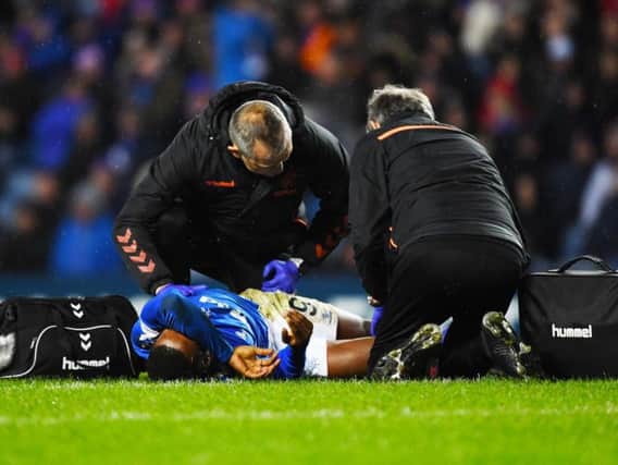 Jermain Defoe receives treatment on the Ibrox turf
