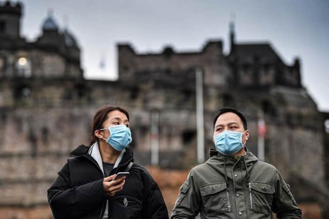 Tourists wear face masks as they visit Edinburgh castle. Picture: Jeff J Mitchell / Getty