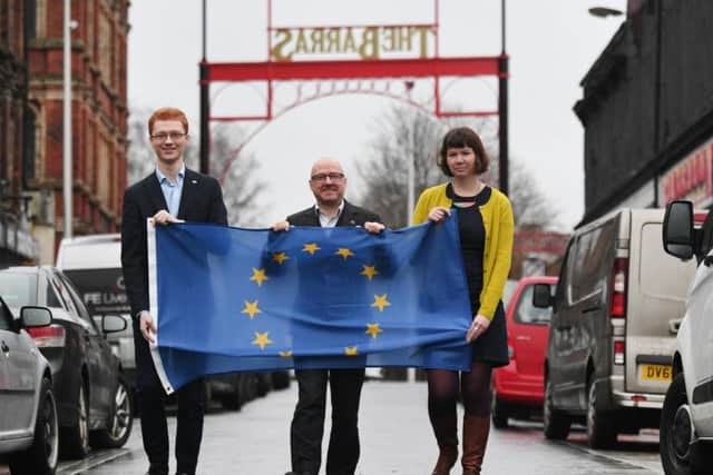 From left, Scottish Greens members Ross Greer, Patrick Harvie and Cass MacGregor display a European flag at the Barras market in Glasgow on the day the UK officially leaves the EU. Picture: John Devlin