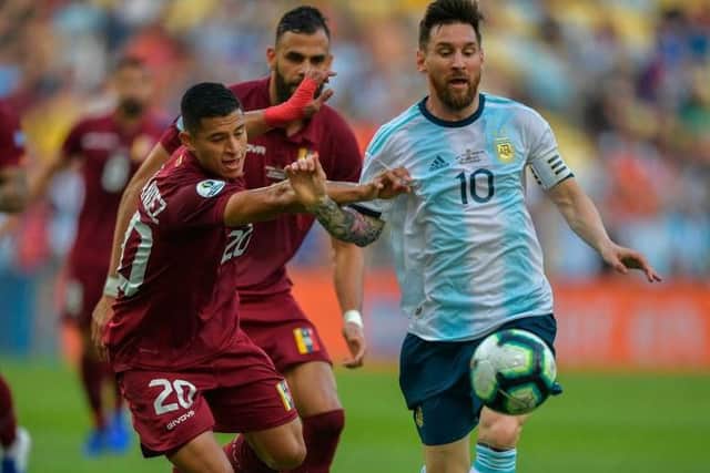 Ronald Hernandez playing against Lionel Messi in a friendly between Venezuela and Argentina.