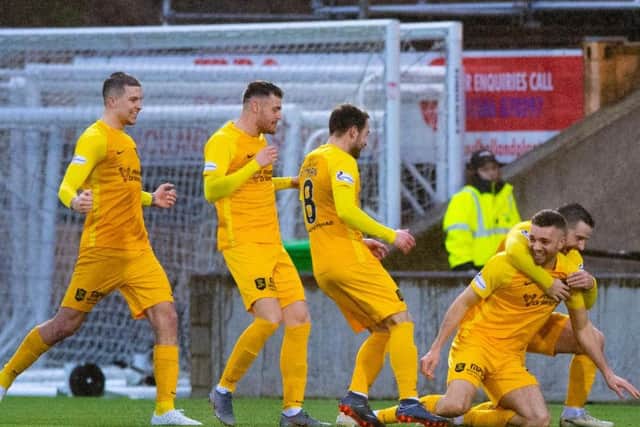 Livingstons Aaron Taylor-Sinclair (R) celebrates his goal with teammates.