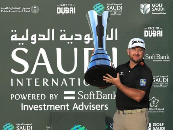 Graeme McDowell shows off the magnificent Saudi International Trophy after his win at Royal Greens Golf Club in King Abdullah Economic City