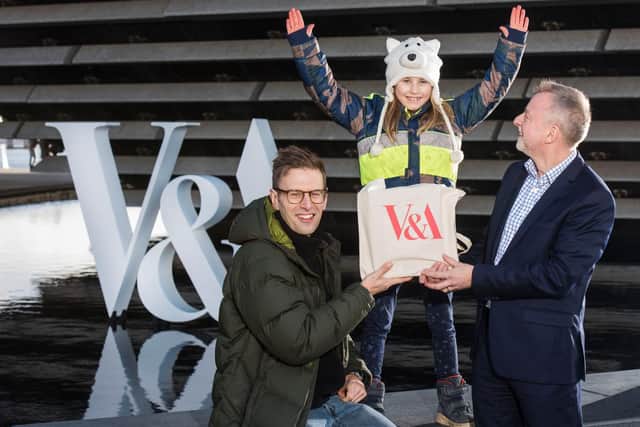 V&A director Philip Long presents seven-year-old Nalani Becker, from Berlin, with a goodie bag after she became its millionth visitor today.
