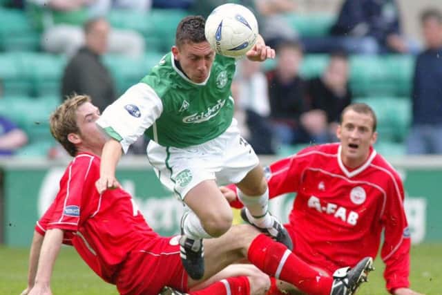 Scott Brown is tackled by Philip McGuire (left) and Paul Sheerin during his Hibs debut against Aberdeen in May 2003. Picture: Alan Harvey/SNS