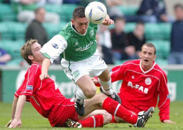 Scott Brown is tackled by Philip McGuire (left) and Paul Sheerin during his Hibs debut against Aberdeen in May 2003. Picture: Alan Harvey/SNS