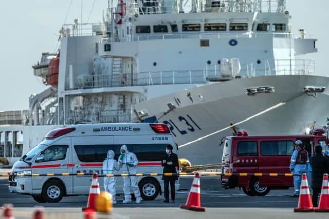 An ambulance carries a coronavirus patient on the dock at Yokohama. Picture: Carl Court