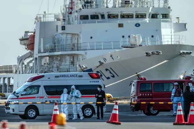An ambulance carries a coronavirus patient on the dock at Yokohama. Picture: Carl Court