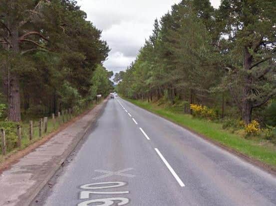 Two men dead after car hits tree, closing Highland road for eight hours