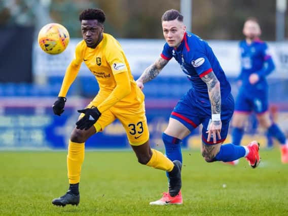 Steve Lawson and Inverness attacker Miles Storey battle for possession. Picture: SNS