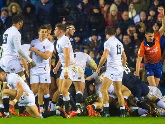 England players celebrate Ellis Genge's late winning try at a windswept and rain-soaked BT Murrayfield. Picture: SRU/SNS