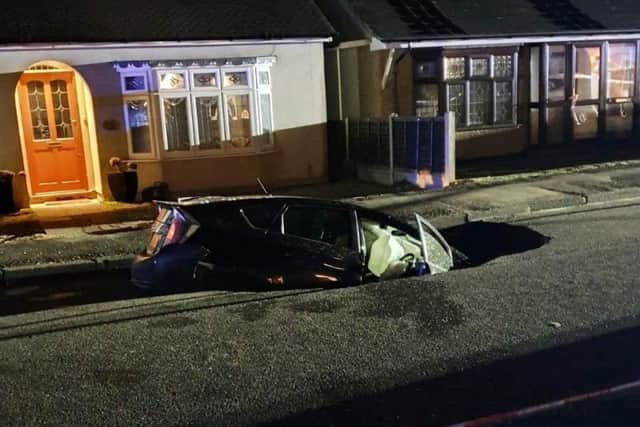A motorist made a miracle escape after their car was swallowed by a sinkhole. Picture: SWNS