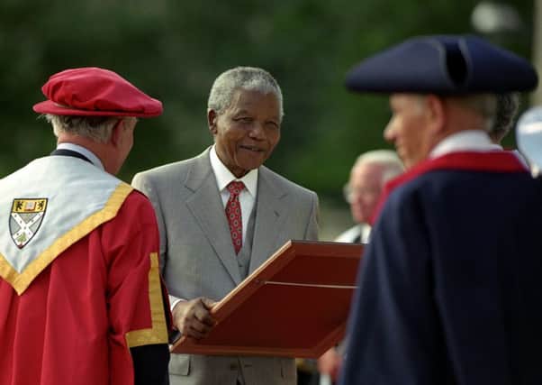 Nelson Mandela receives honorary degrees from eight British uiversities at Buckingham Palace