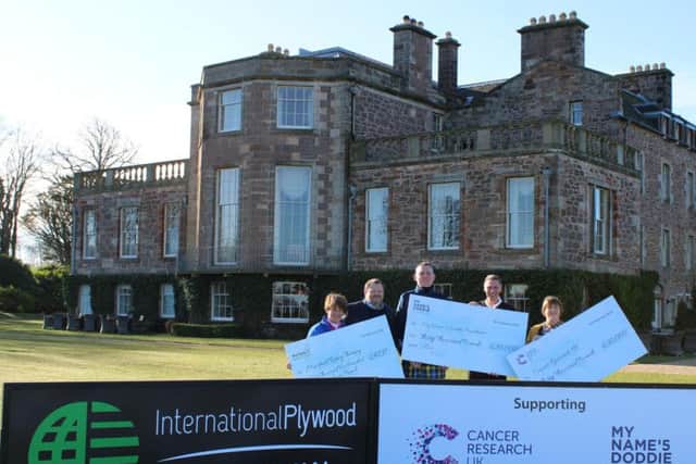Doddie Weir and representatives of the two other charities receive their cheques from Ian Attwood, managing director of International Plywood, and Tom Younger, chief executive of Archerfield Links, at Archerfield House.