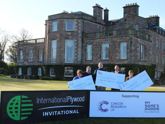 Doddie Weir and representatives of the two other charities receive their cheques from Ian Attwood, managing director of International Plywood, and Tom Younger, chief executive of Archerfield Links, at Archerfield House.
