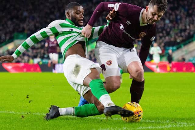 Goalscorer Olivier Ntcham battles for possession with Hearts' Craig Halkett. Picture: SNS