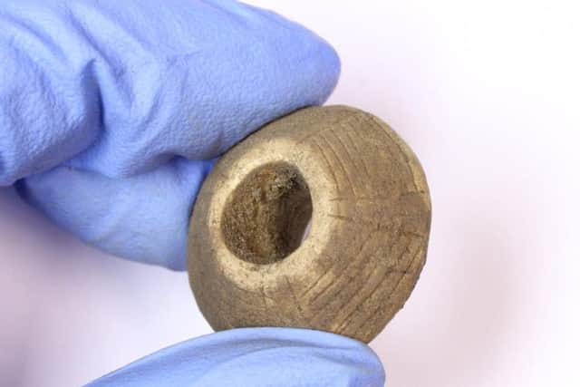 A decorated spindle whorl, which was used in textile production, found at the site. PIC: PKHT.