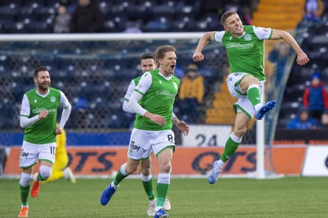 Airborne Greg Docherty celebrates his stunning strike which opened the scoring for Hibs at Kilmarnock. Picture: SNS.