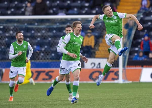Airborne Greg Docherty celebrates his stunning strike which opened the scoring for Hibs at Kilmarnock. Picture: SNS.