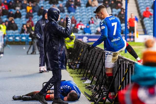 Andy Halliday lays injured after falling over the advertising boards at Ibrox. Picture: SNS