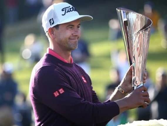 Adam Scott shows off the trophy after his two-shot win in the Genesis Invitational hosted by Tiger Woods in Los Angeles