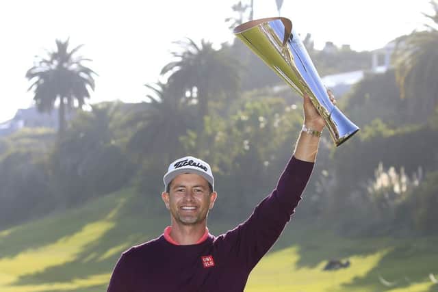 Adam Scott holds aloft the trophy after winning the Genesis Invitational
