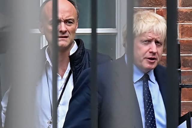 Britain's Prime Minister Boris Johnson (right) and his special advisor Dominic Cummings leave from the rear of Downing Street in central London. Picture: Daniel Leal/Getty Images