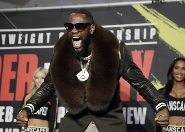 Flamboyant in his fur-trimmed overcoat, Deontay Wilder arrives for a meeting with the media ahead of his fight with Tyson Fury. Picture: AP.