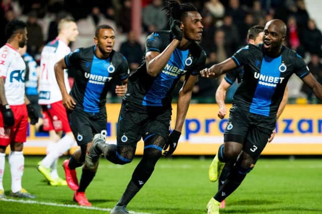 Simon Deli celebrates a goal for Club Brugge against Kortrijk with Eder Balanta