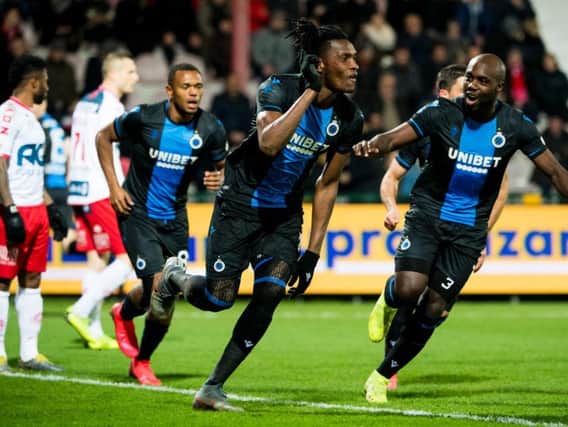 Simon Deli celebrates a goal for Club Brugge against Kortrijk with Eder Balanta