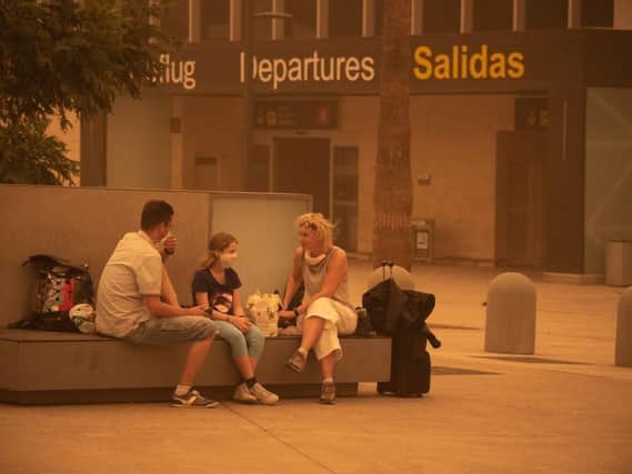 Passengers wait outside Tenerife SouthReina Sofia Airport (Photo: DESIREE MARTIN/AFP via Getty Images)