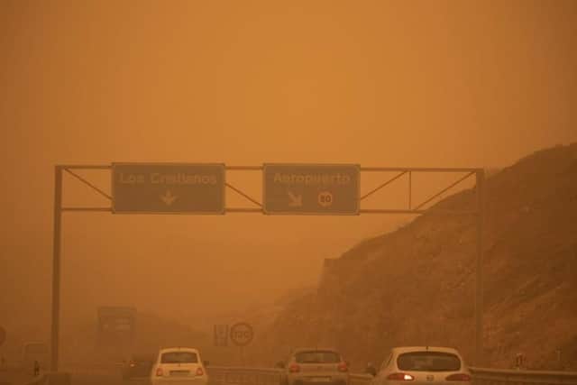 Cars drive on the TF-1 highway during a sandstorm in Santa Cruz de Tenerife, on the Canary Island of Tenerife (Photo: DESIREE MARTIN/AFP via Getty Images)