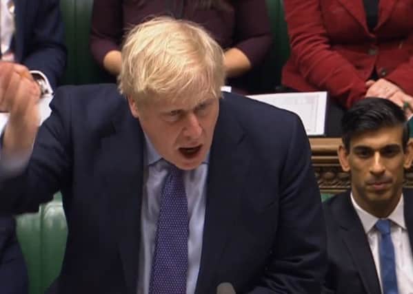 Boris Johnson and new Chancellor Rishi Sunak in the House of Commons (Picture: AFP via Getty Images)