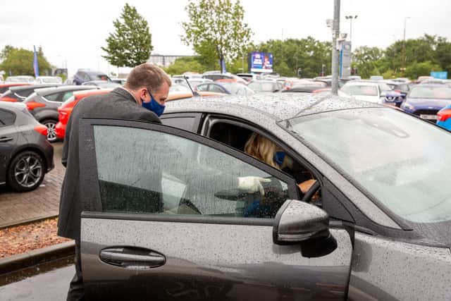 Face masks and gloves are a standard part of the uniform for staff when dealing with customers (Photo: Ford)